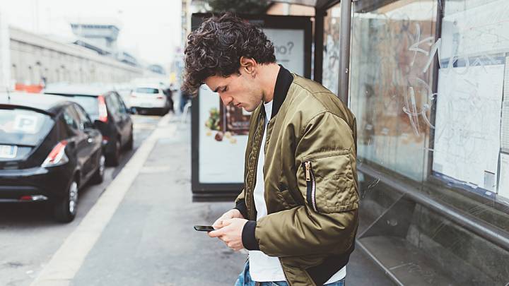 young man researching gonorrhoea on his phone