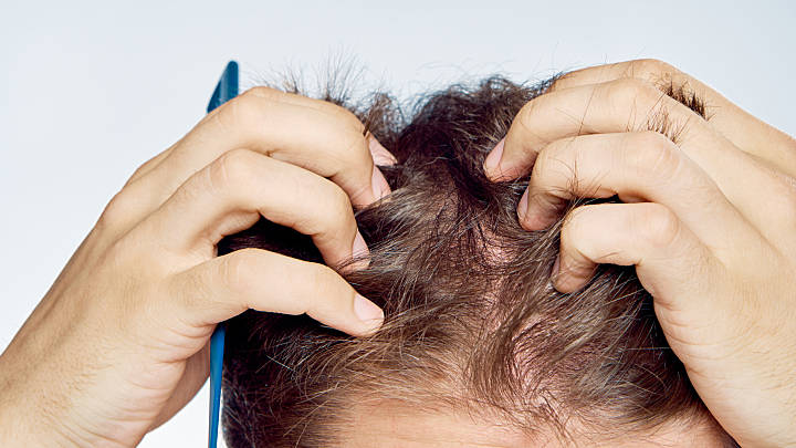 Somebody feeling their own head hair