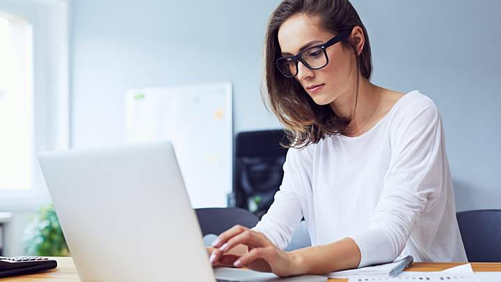 Woman looking up what herpes is on her laptop