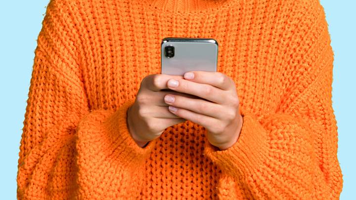 young woman researching chlamydia symptoms on her phone