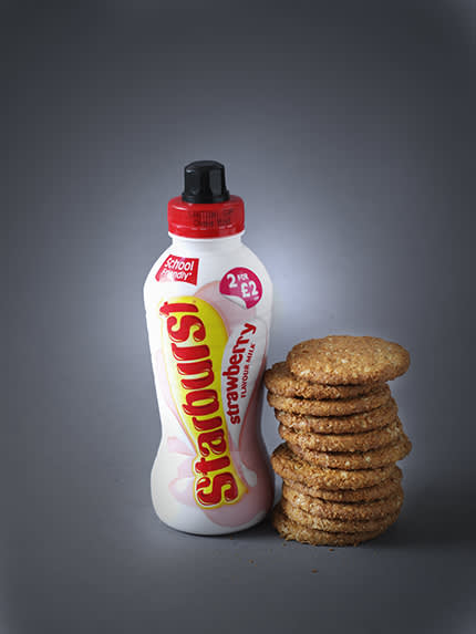 bottle of starburst next to a stack of hobnobs
