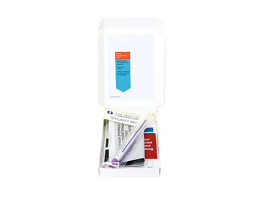 An open box containing a swab test kit