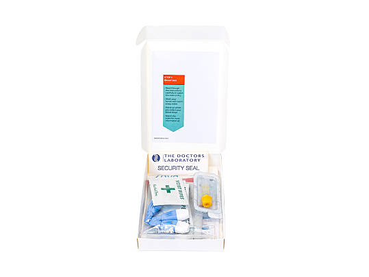 An open box containing a blood test kit