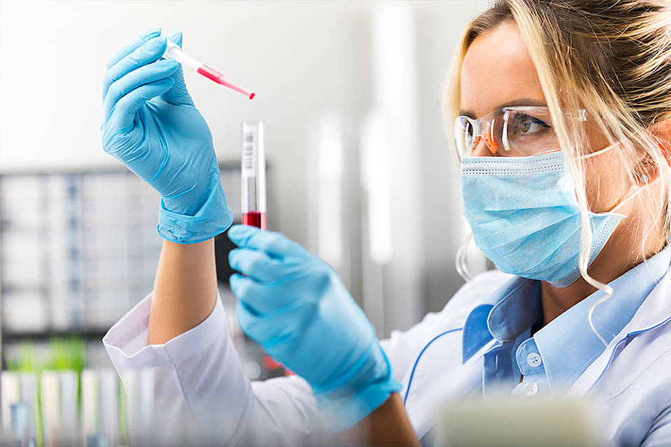 Woman with test tube and pipette