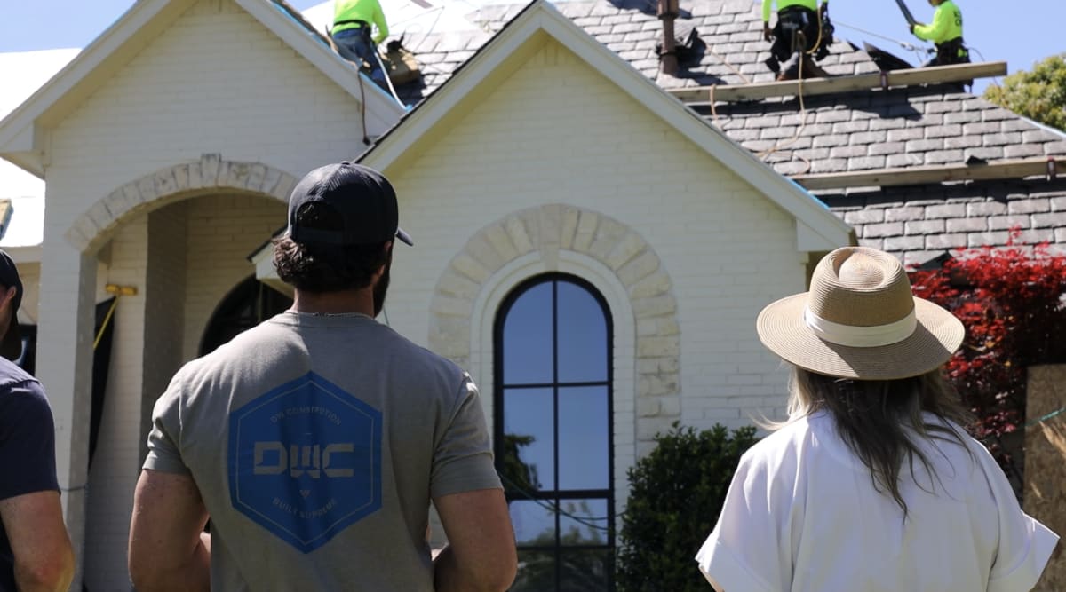 DW Construction team reviewing a luxury roofing project