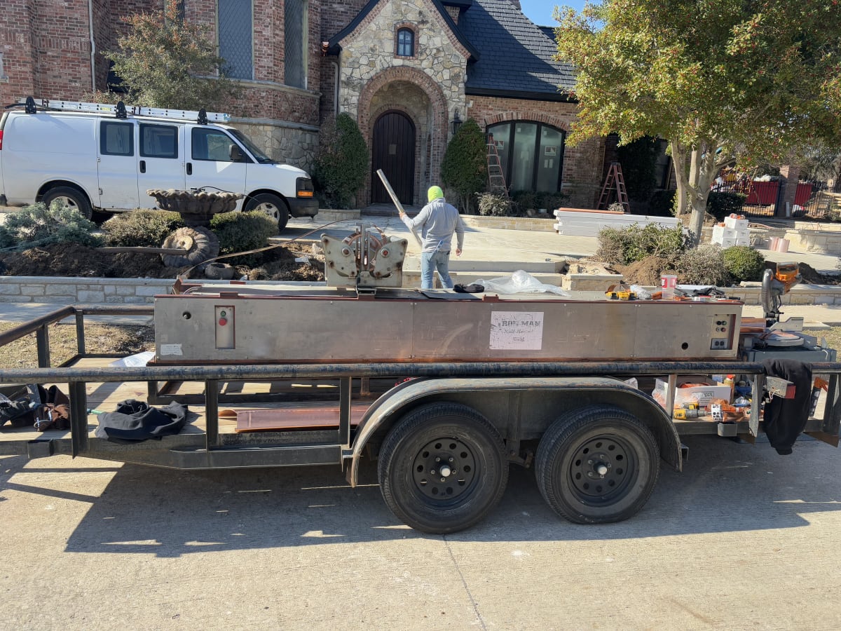 DW Construction fabricating standing seam metal panels on site at a Fort Worth area home