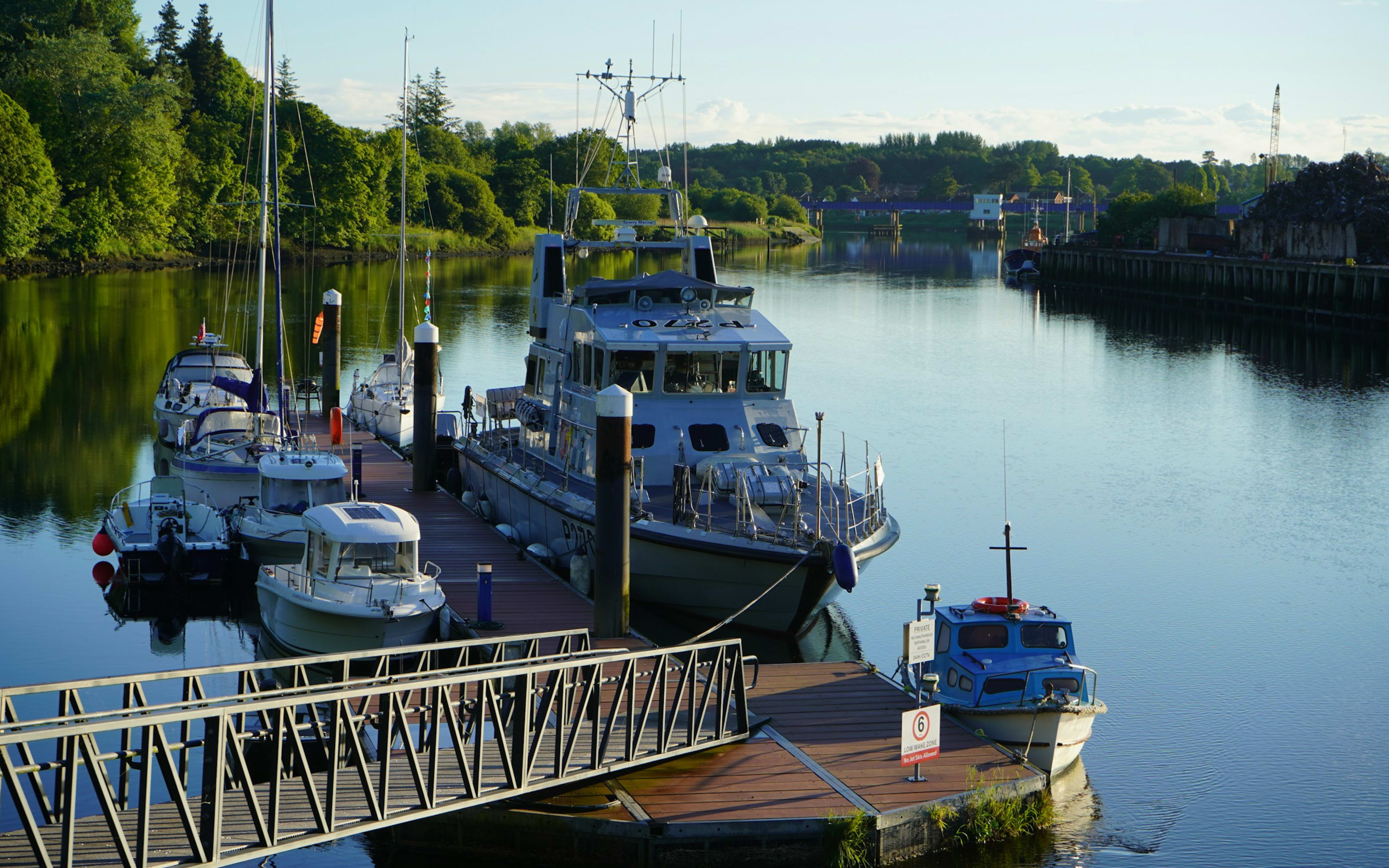 Sample photo of boats moored at a pontoon jetty on a river