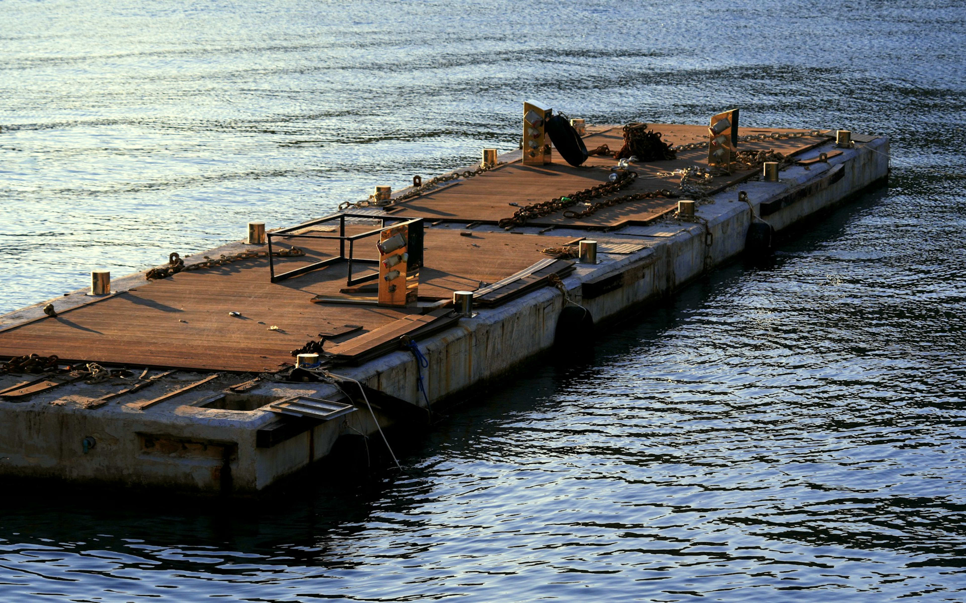 Sample photo of a flat-top deck barge on calm water