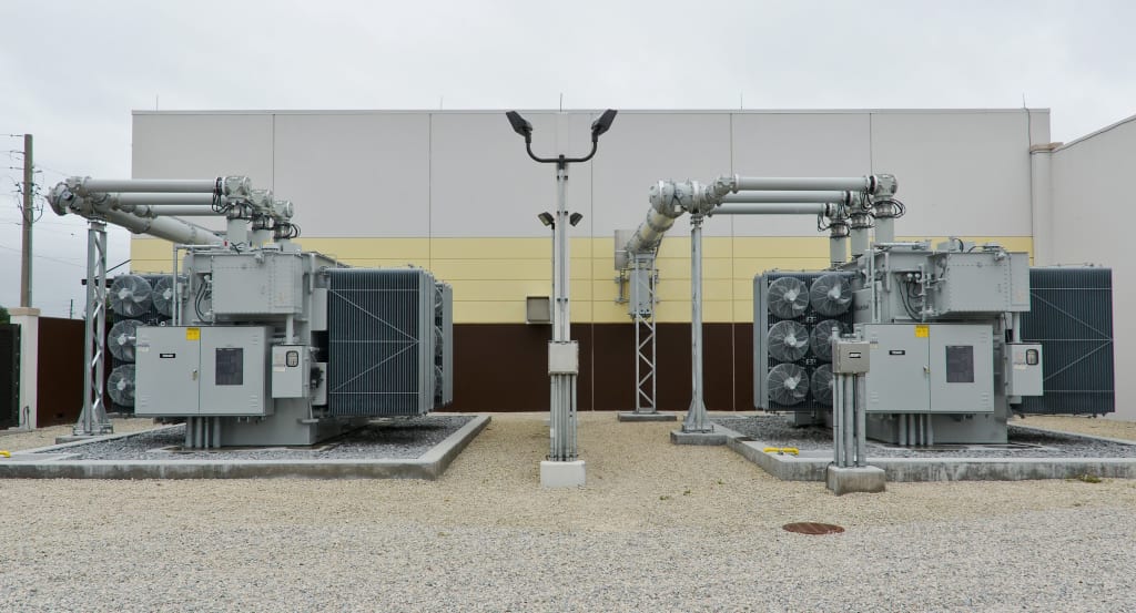 High-voltage switchgear and busbars inside a transmission substation.