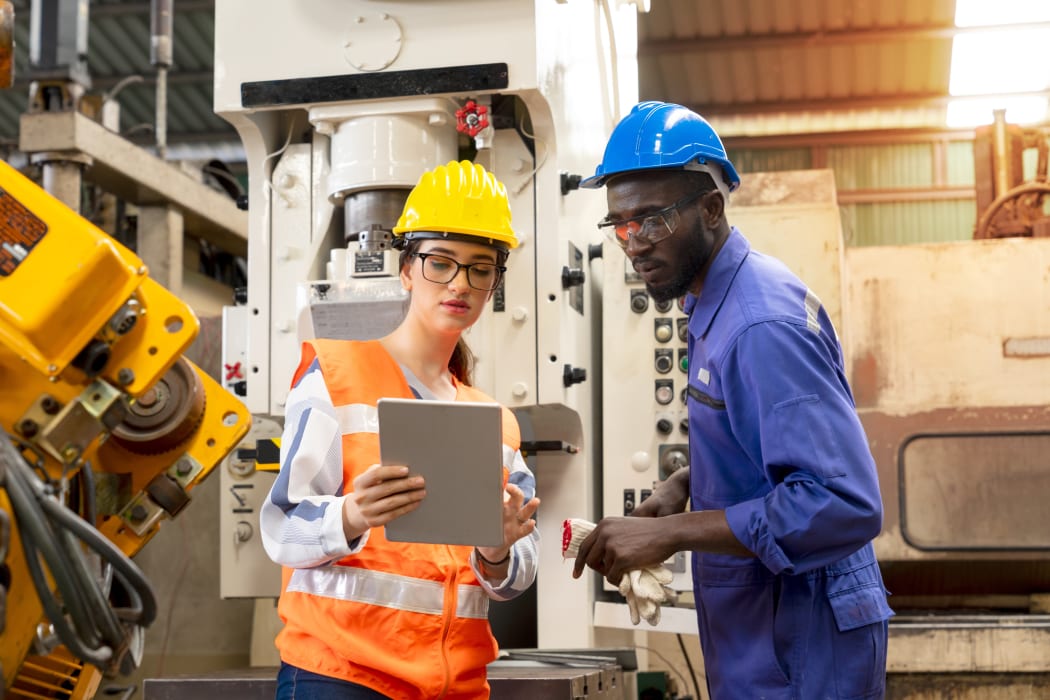 people wearing hardhats in manufacturing
