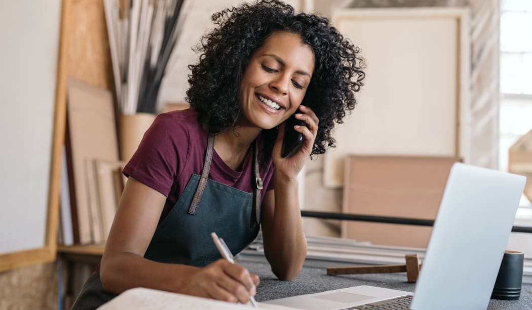 woman in apron on phone