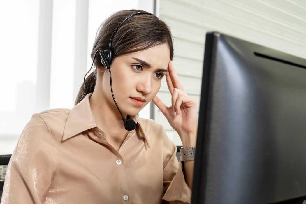 pensive woman in call center