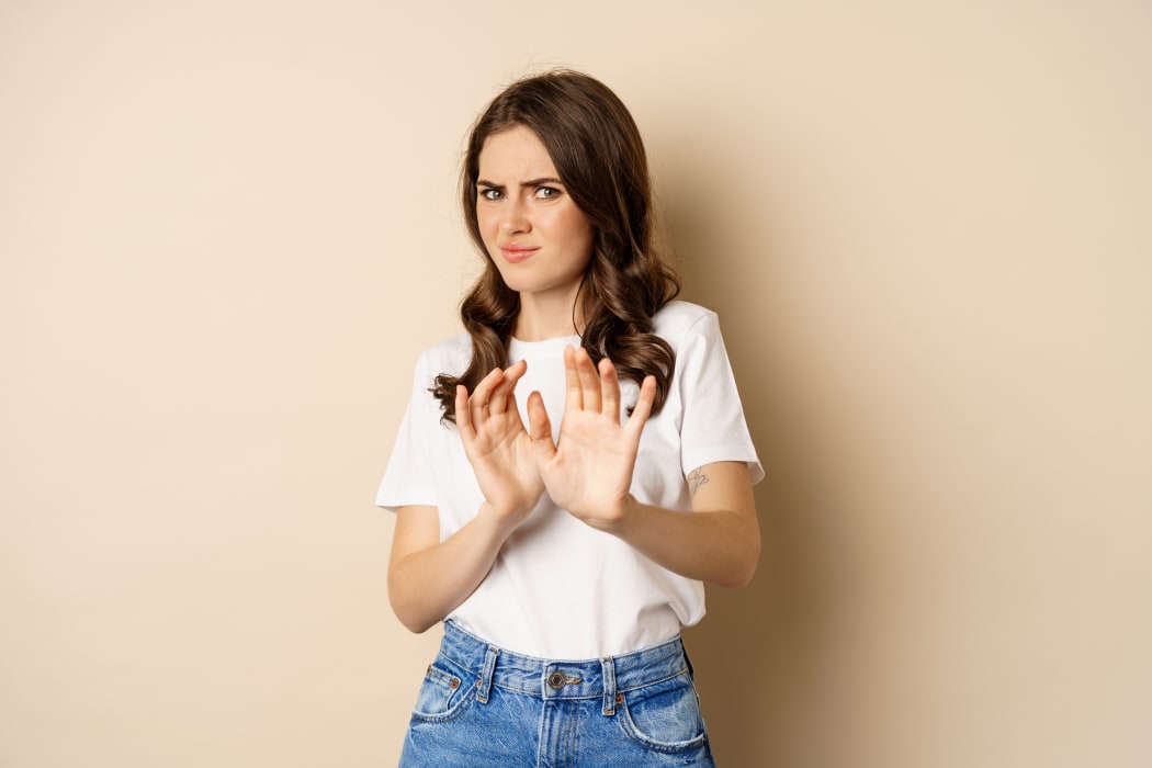 woman cringing