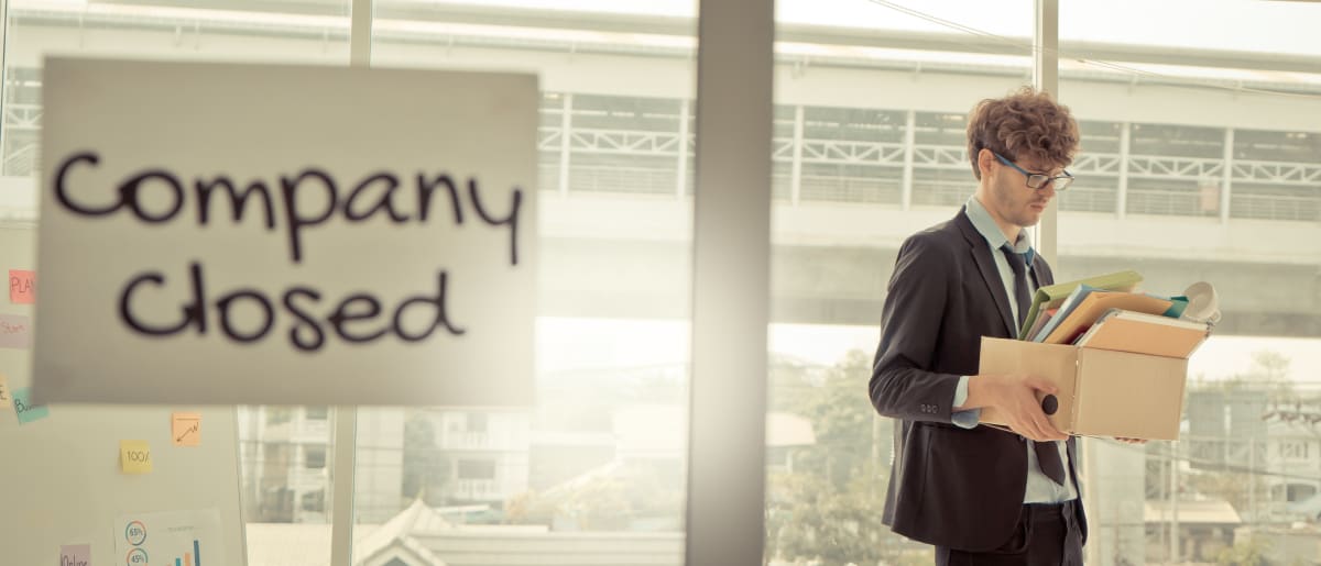 man packing up his things after dissolving his business