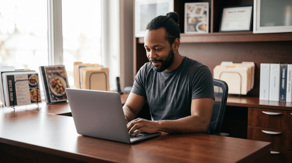 Food truck owner registering a food truck business as an LLC on computer