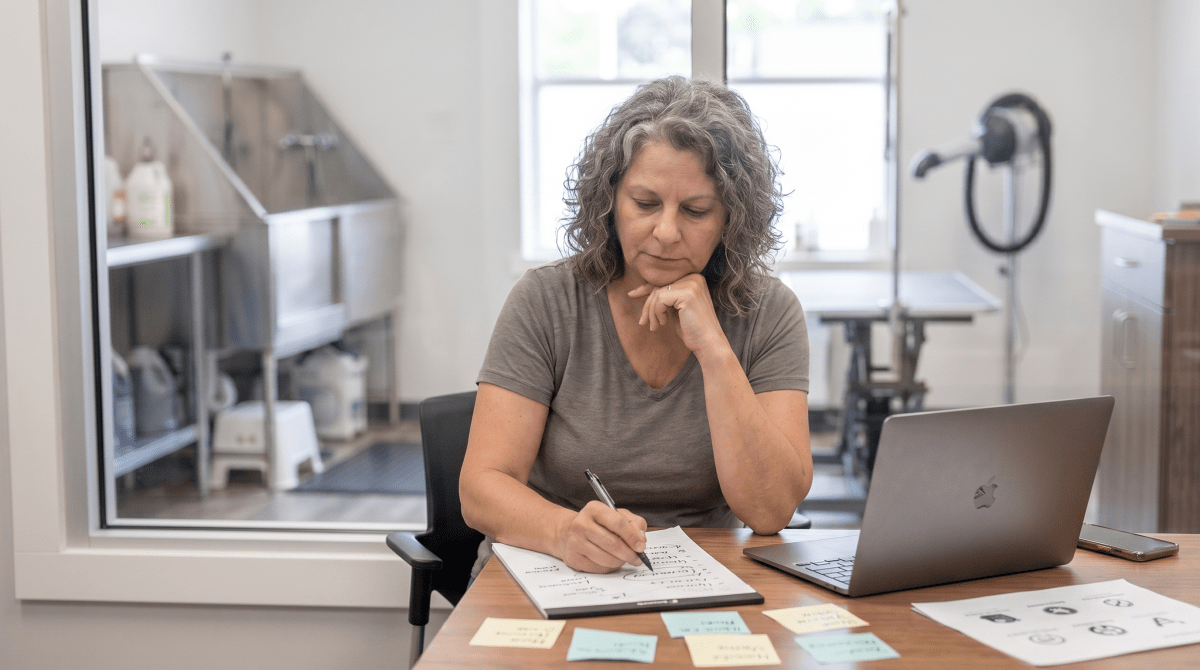 Dog grooming salon owner reviewing LLC business name ideas