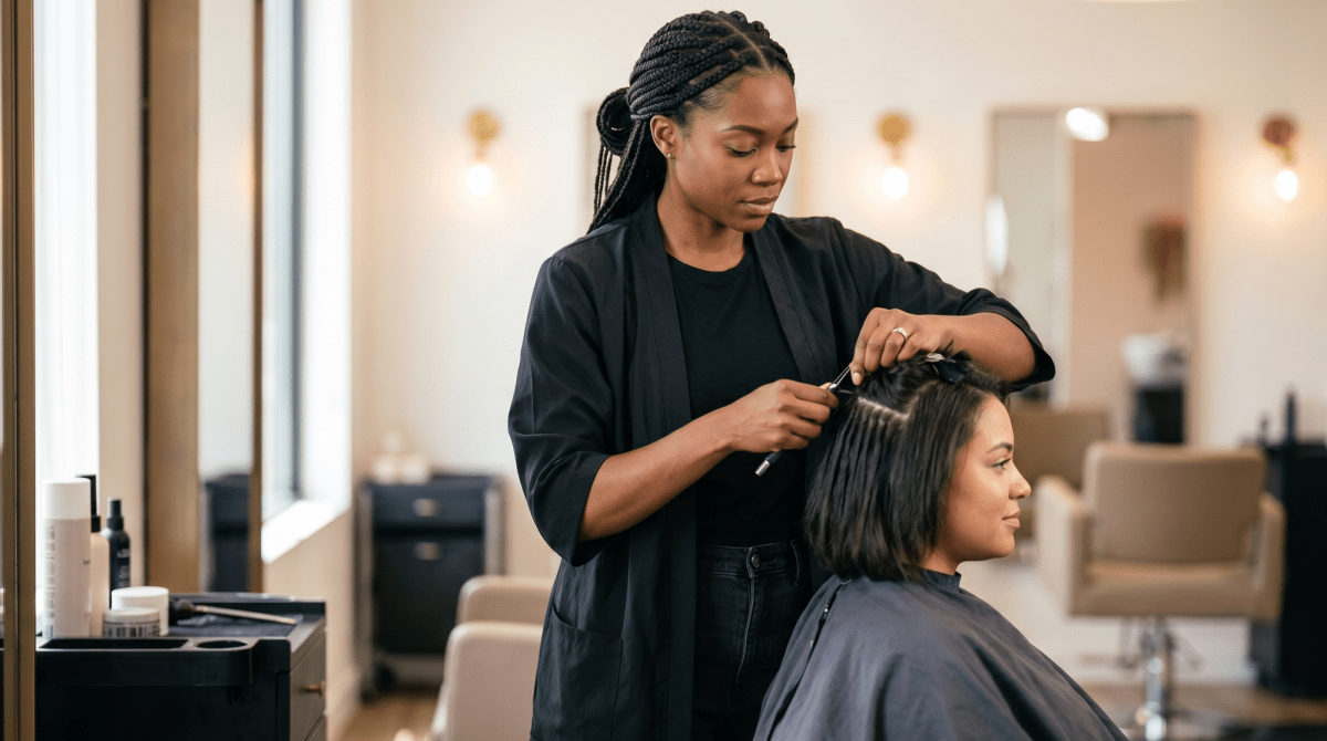 Applying hair extensions to a client at a specialty studio