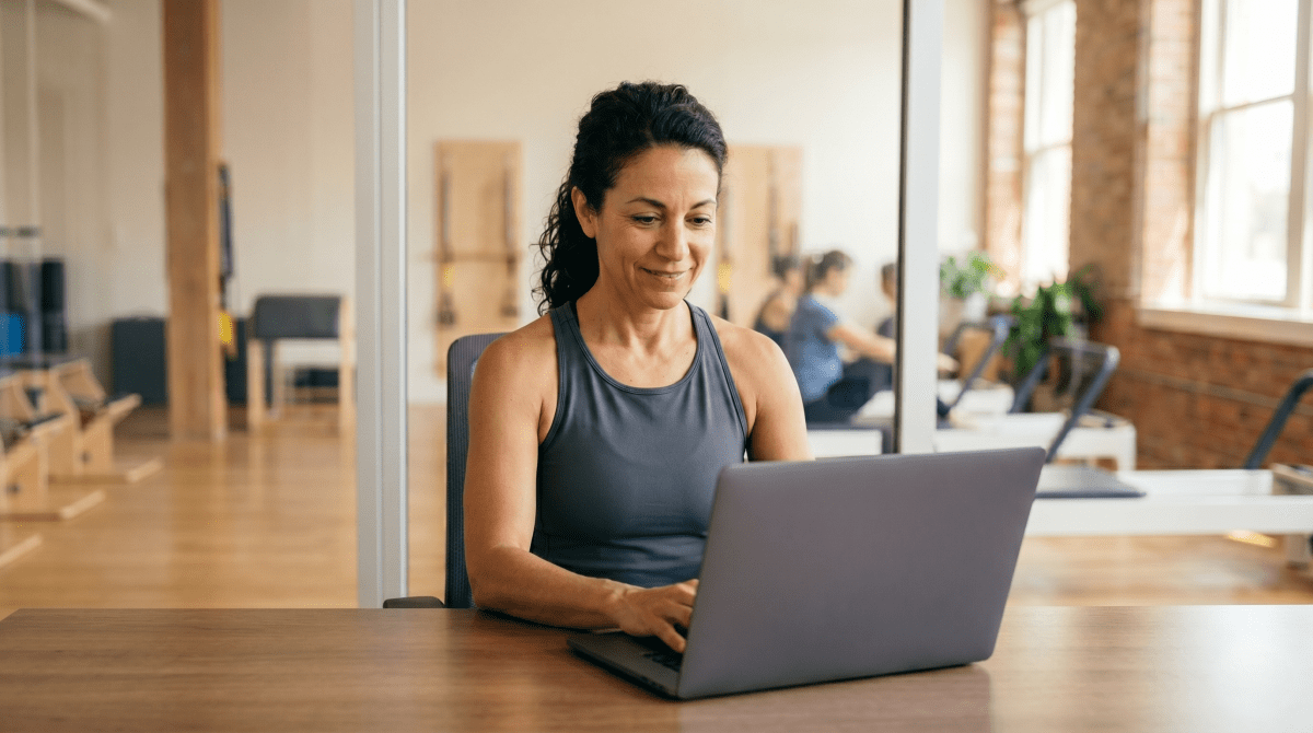 Pilates instructor registering a Pilates business as an LLC from workspace