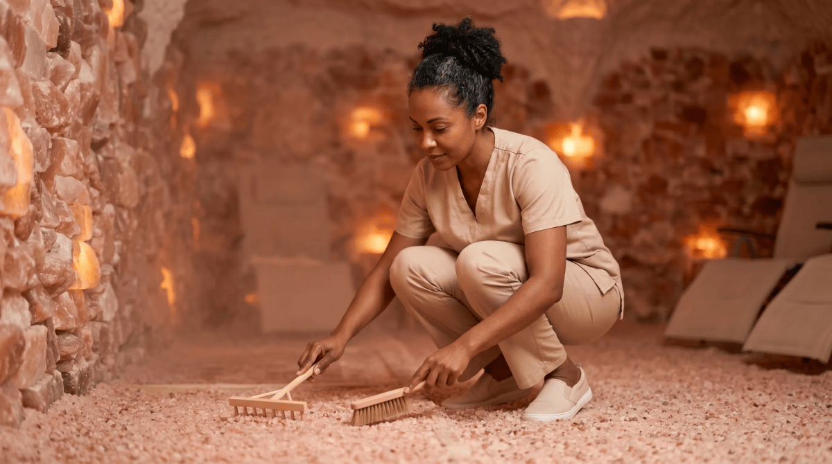 Salt cave spa owner preparing a halotherapy room for guests