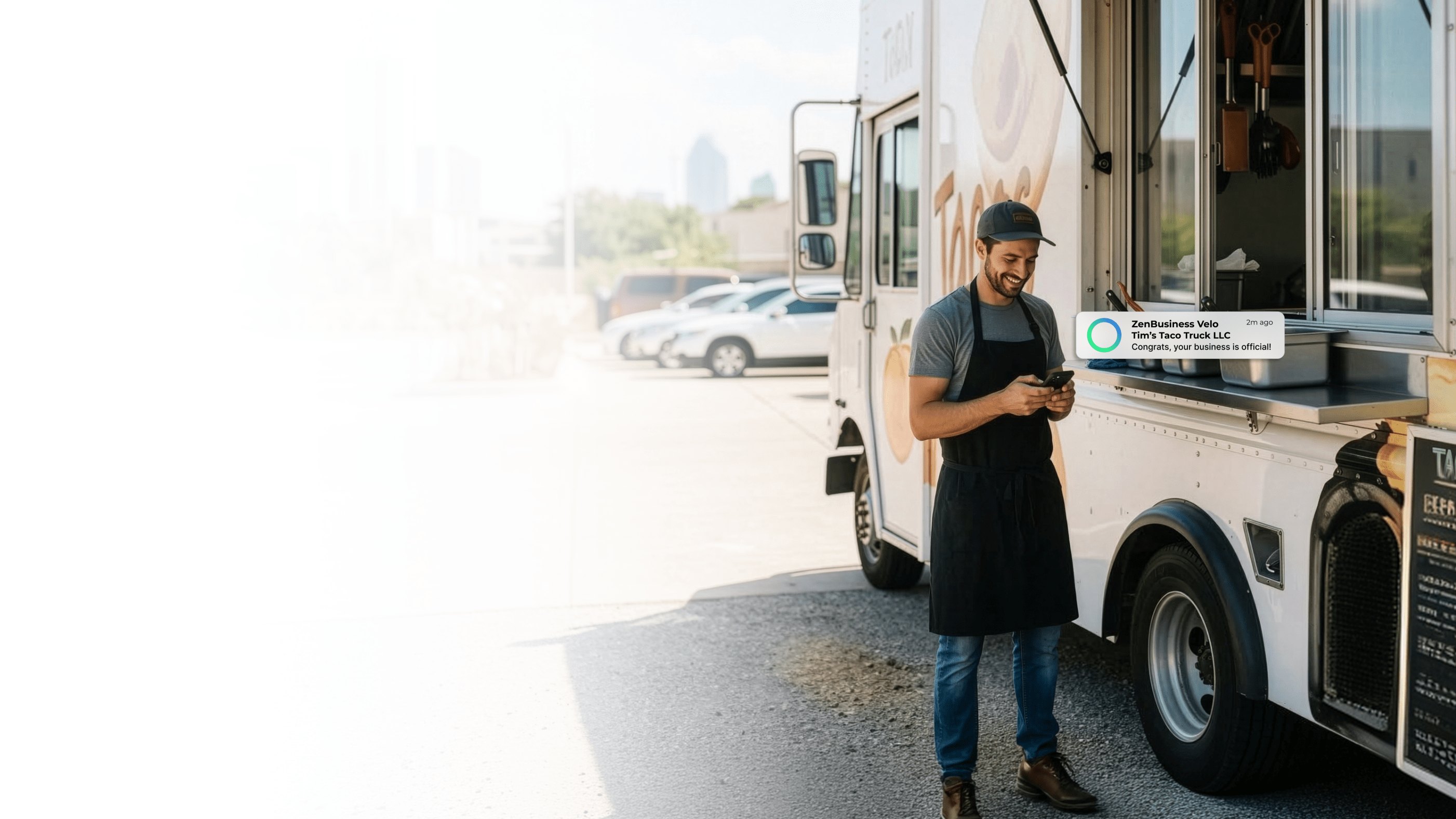 Male food truck owner outside his taco truck in Dallas Texas checking his ZenBusiness Velo notification confirming his LLC is officially approved