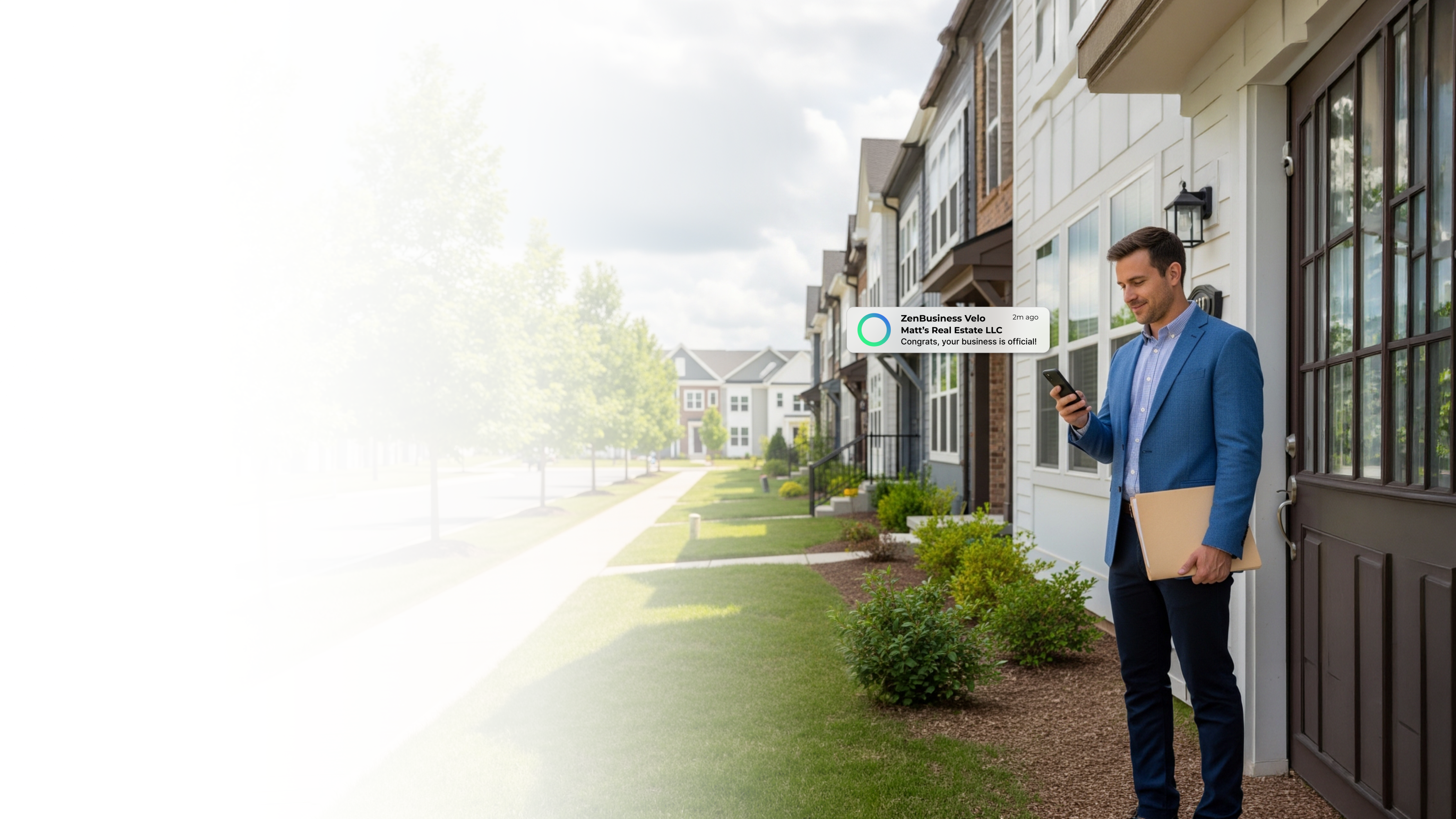 Male real estate professional outside a row of homes on a tree-lined street in Northern Virginia checking his ZenBusiness Velo notification that his LLC is official