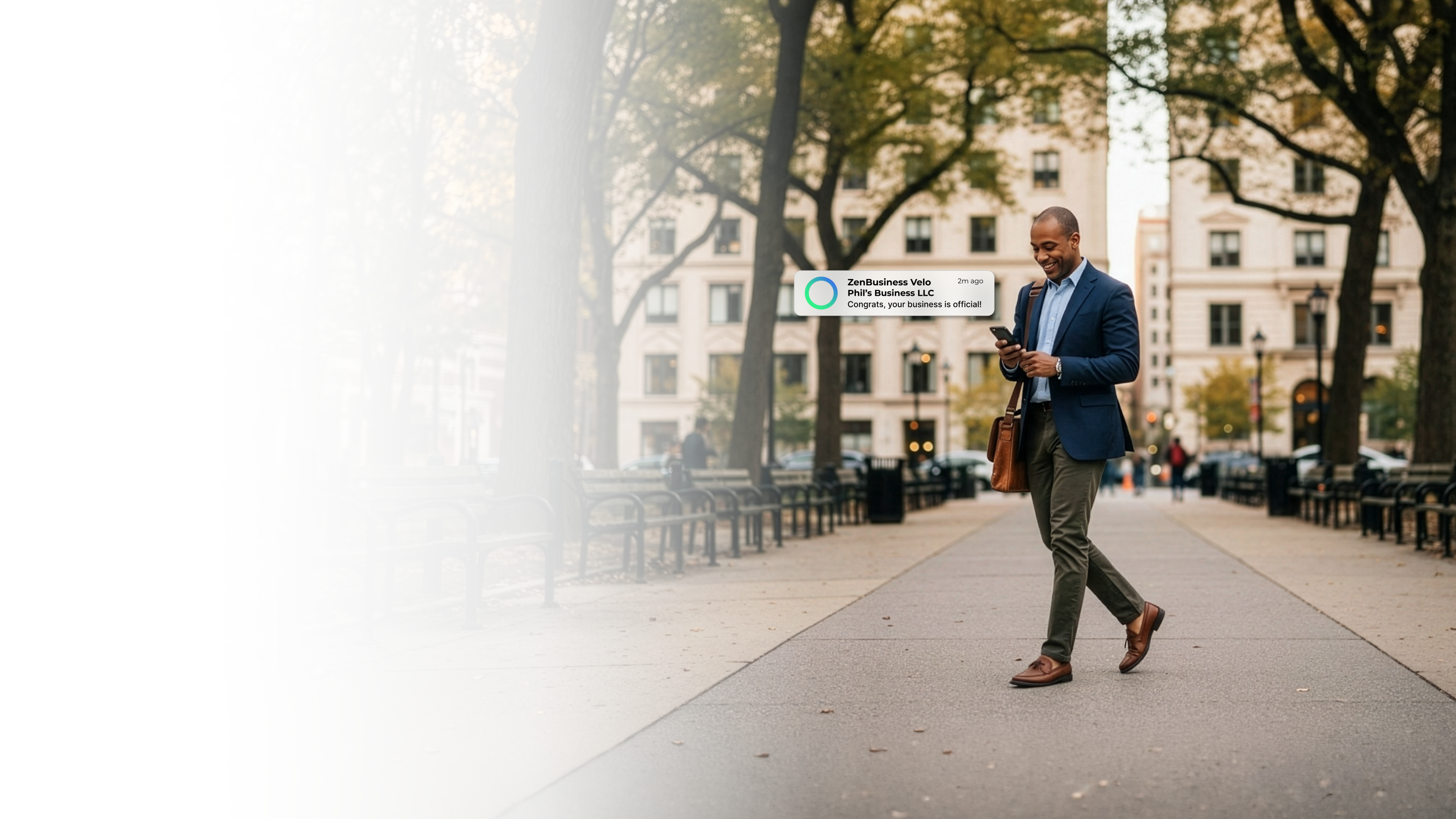 Male business professional walking through a tree-lined boulevard in Philadelphia Pennsylvania after ZenBusiness Velo confirmed his LLC is official