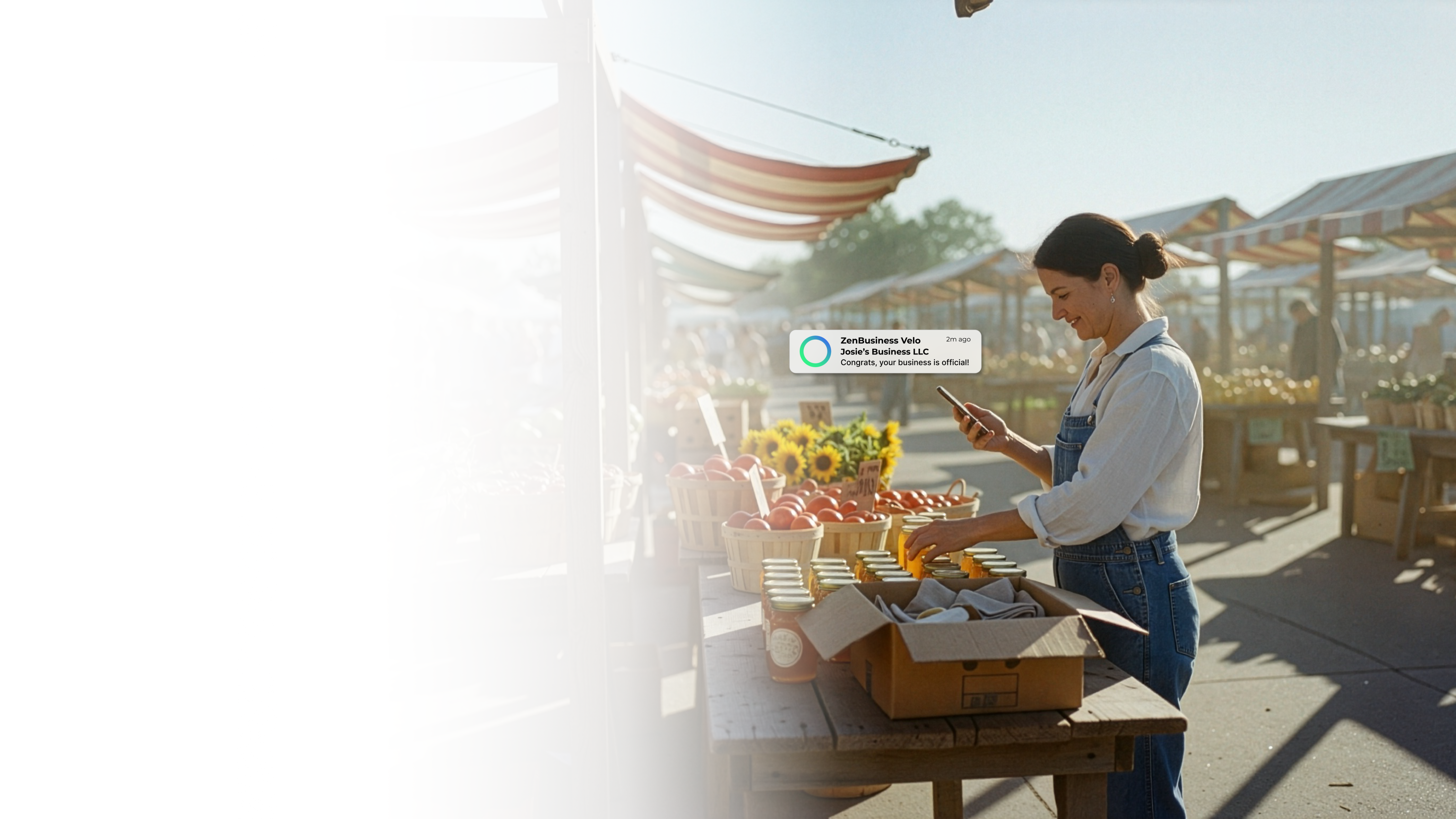 Female farmers market vendor in South Dakota checking her ZenBusiness Velo notification that her LLC is official while arranging sunflowers and fresh produce at her outdoor market stand