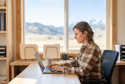 Business owner working on their Colorado corporation at a laptop