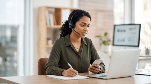 B2B lead generation agency business owner working at a desk reviewing prospect data and outreach strategies