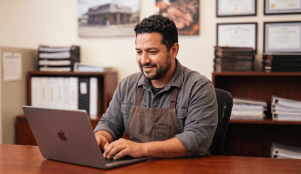 BBQ restaurant owner registering a BBQ business as an LLC on laptop