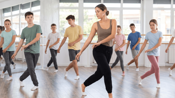 Dance studio owner leading a class in a mirrored studio