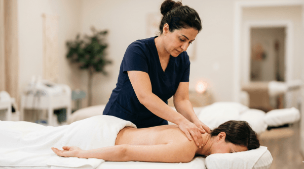Day spa owner providing a relaxing spa treatment at a wellness and beauty business