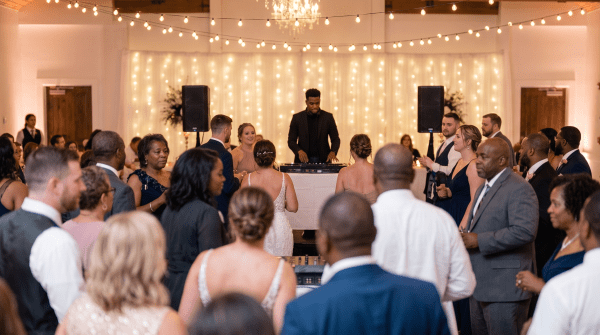 DJ setting up turntables and speakers before an event