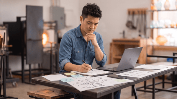 Glass art studio owner brainstorming business name ideas