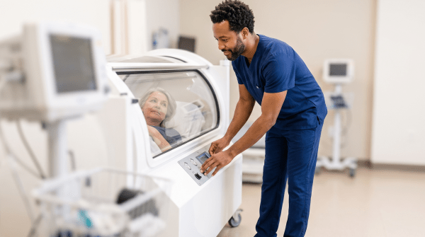 Hyperbaric oxygen therapy center owner operating a hyperbaric oxygen chamber