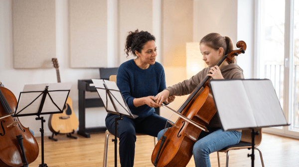 Music teacher guiding a student through a lesson with instruments