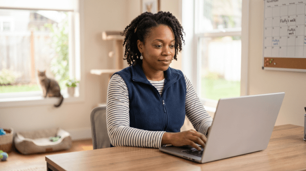 Pet sitter registering a pet sitting business as an LLC on a laptop