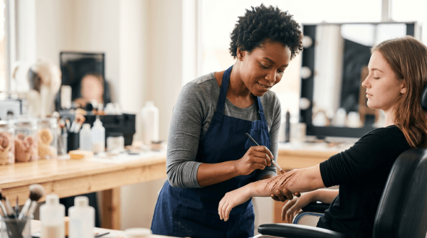 SFX makeup artist applying special effects makeup for film, theater, or entertainment productions