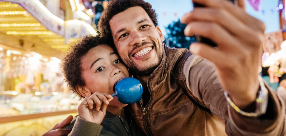 father and son taking a selfie at a carnival. #greenlight