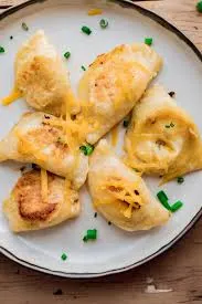 Potato & Cheese Pierogi Lunchbox with Caramelized Onions and Mustard Sauce Potato & Cheese Pierogi Lunchbox with Caramelized Onions and Mustard Sauce