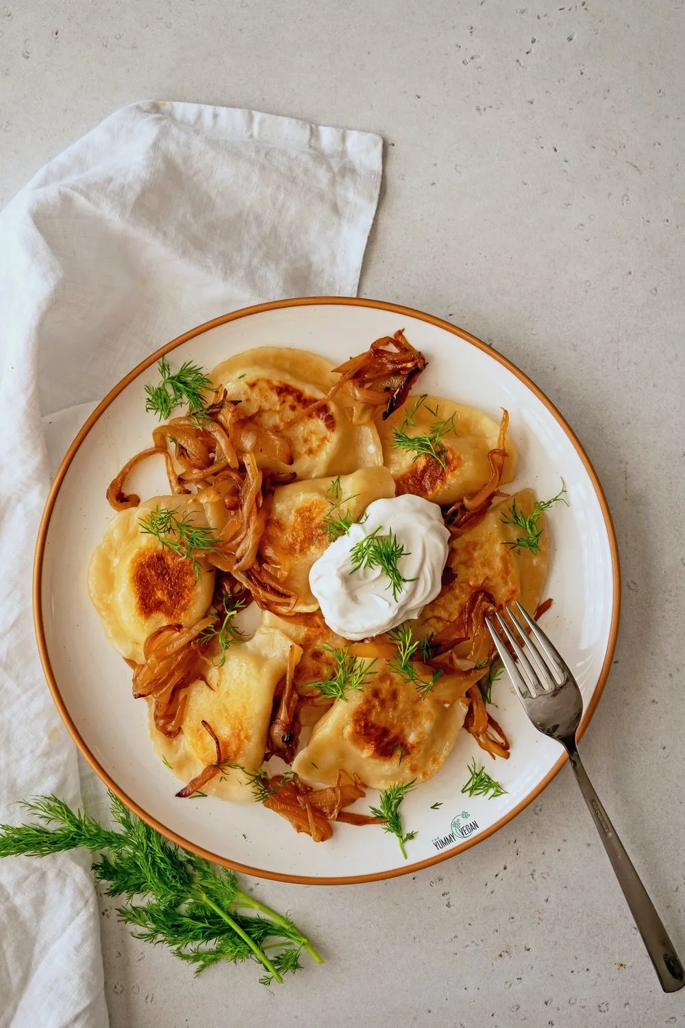 Vegan Sauerkraut Pierogi Lunchbox with Caramelized Onions and Vegan Sour Cream & Chives Sauce Vegan Sauerkraut Pierogi Lunchbox with Caramelized Onions and Vegan Sour Cream & Chives Sauce