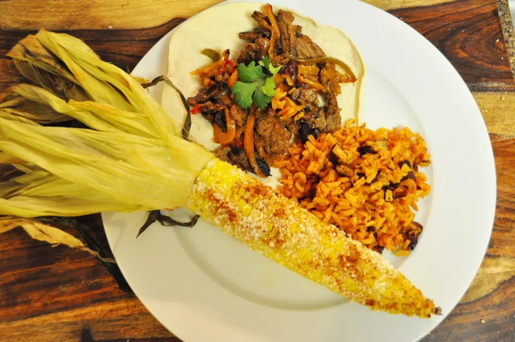 Beef Fajitas with Corn Tortilla, Yellow Rice & Mexican Corn on the Cob (Sour Cream, Salsa) Beef Fajitas with Corn Tortilla, Yellow Rice & Mexican Corn on the Cob (Sour Cream, Salsa)