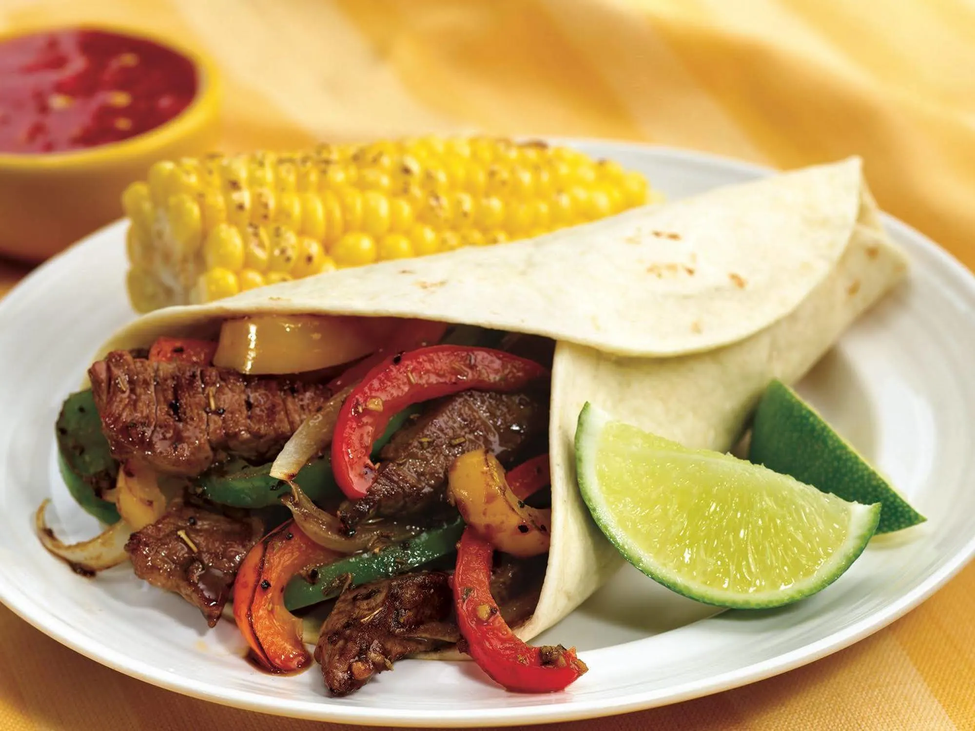 Beef Fajitas with Flour Tortilla, Yellow Rice & Mexican Corn on the Cob (Sour Cream, Salsa) Beef Fajitas with Flour Tortilla, Yellow Rice & Mexican Corn on the Cob (Sour Cream, Salsa)
