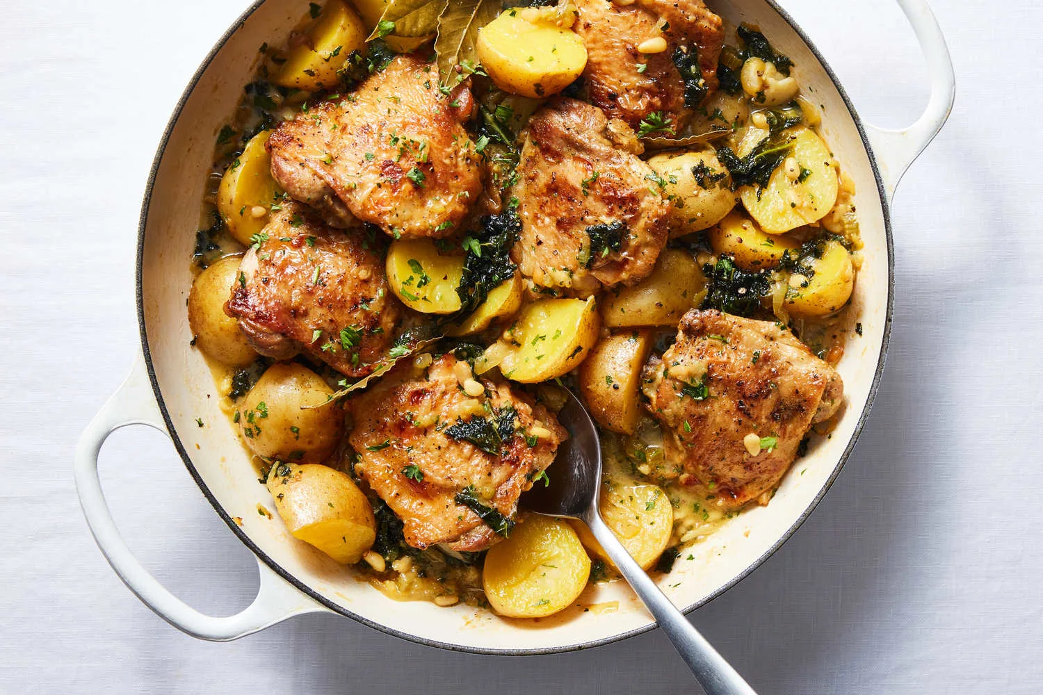 Braised chicken thighs with arugula pesto served with herb roasted new potatoes