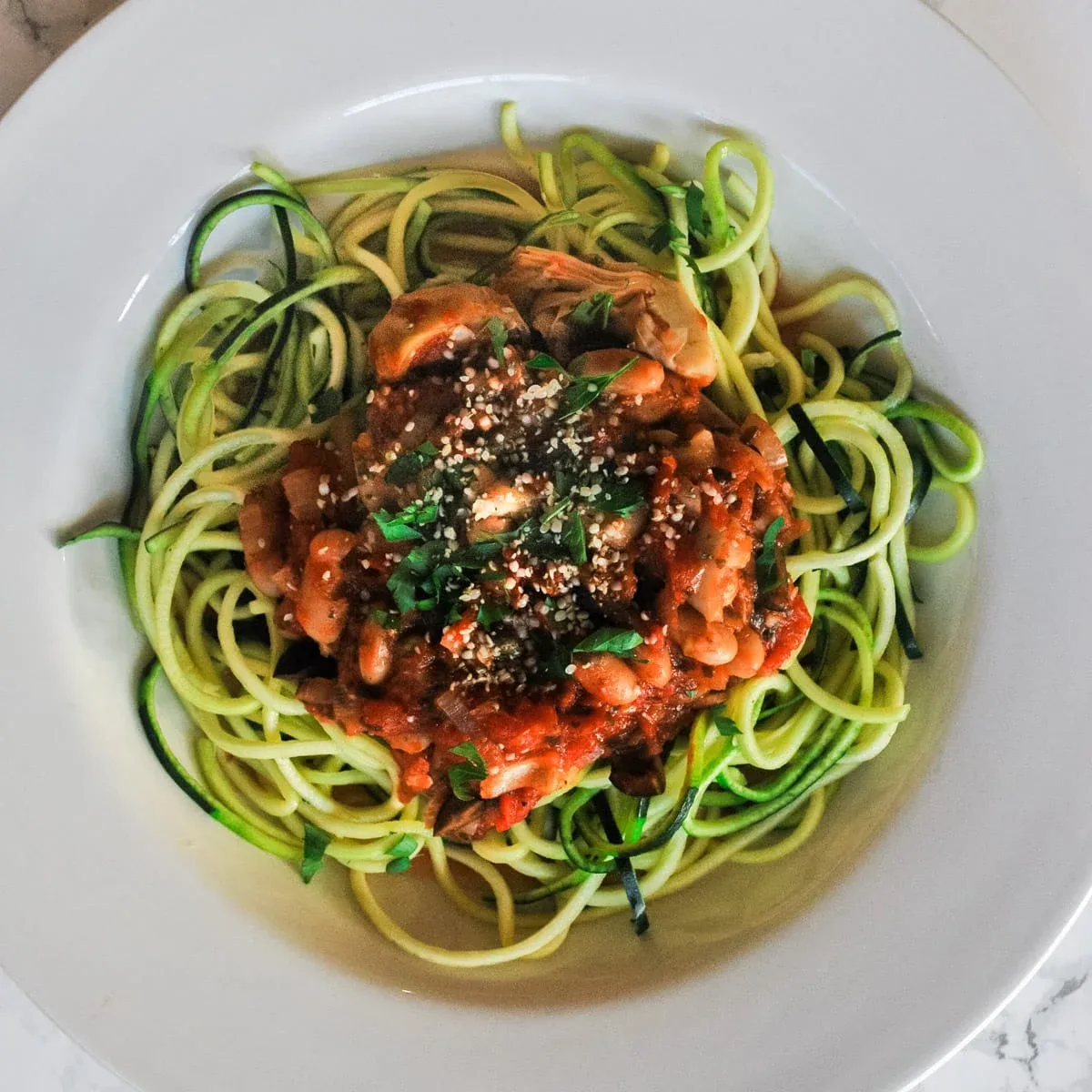 Plant based ground "meat" over zoodled zucchini "noodle"