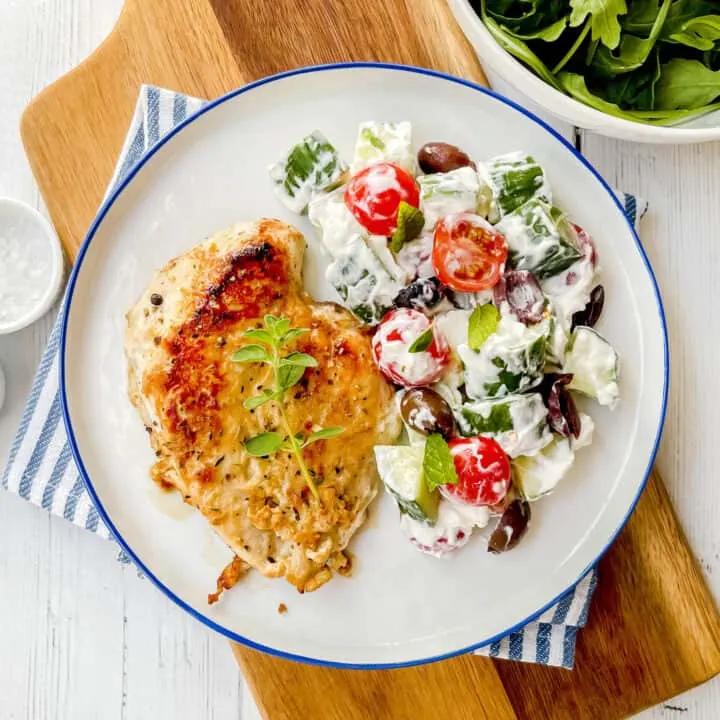 Yogurt-tumeric chicken served with tomato-cucumber-feta salad
