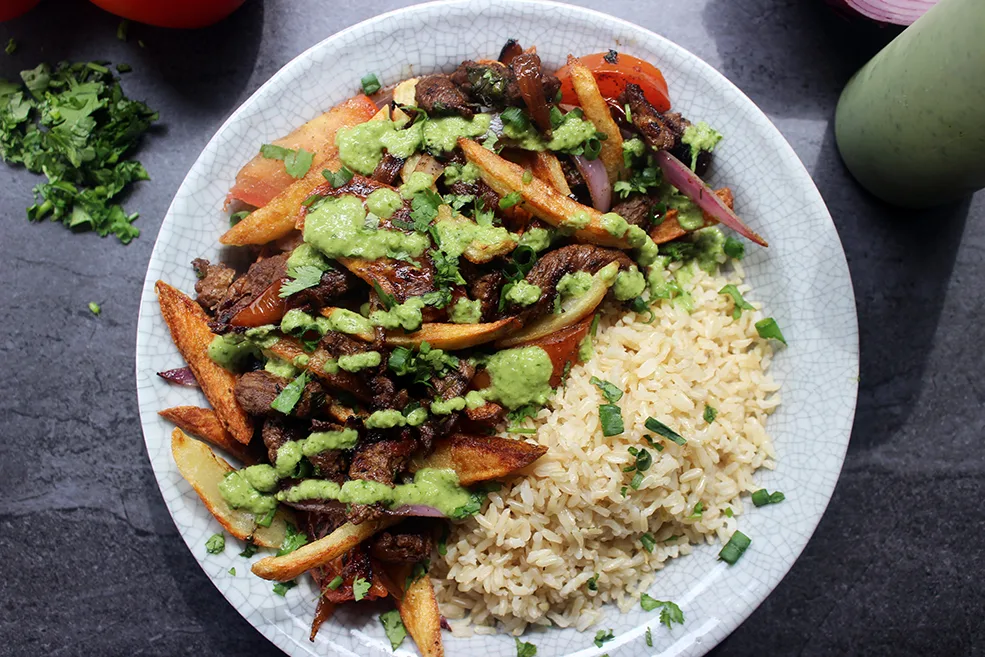 Seco de Pollo and Lomo Saltado with Andean Rice and Herb Roasted Veggies Seco de Pollo and Lomo Saltado with Andean Rice and Herb Roasted Veggies