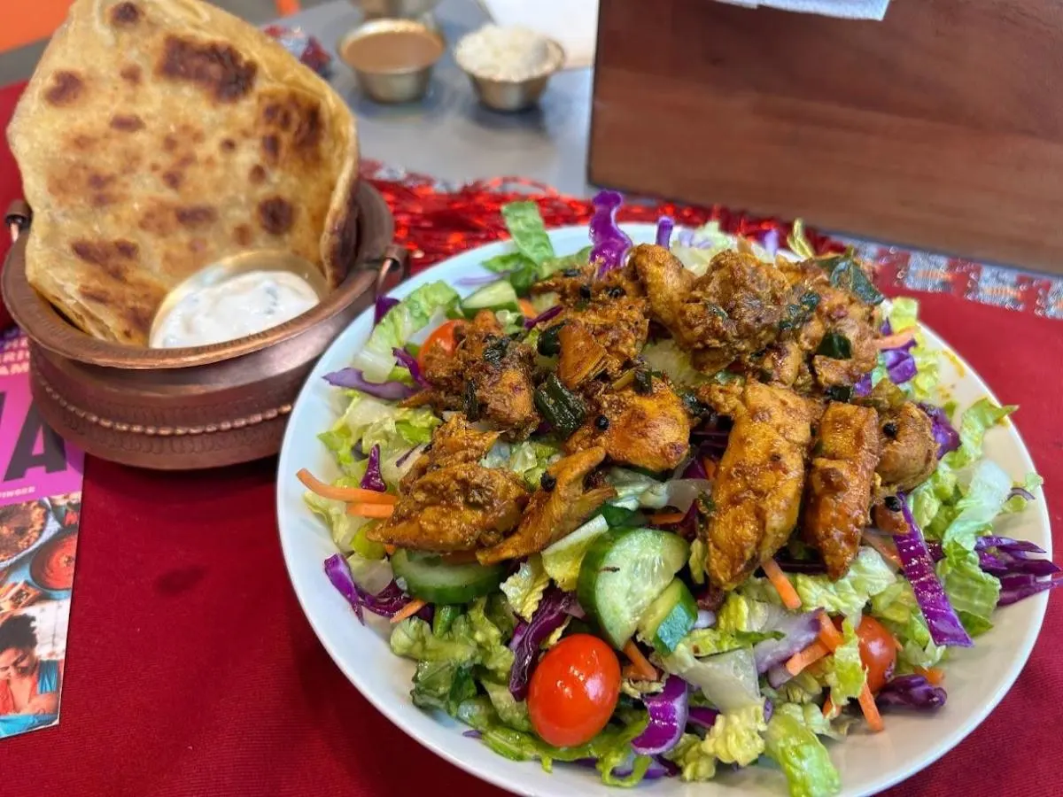 Grilled Nepali Chicken Entree Salad with Roti and Raita.