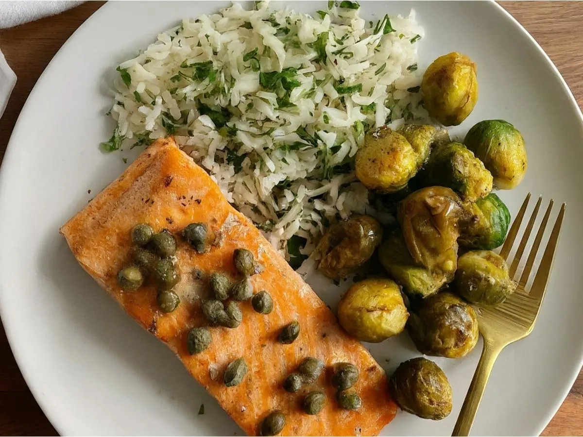 Roasted Salmon Served with Capers Served with Rosemary Jasmine Rice & Chili Crisp Brussels Sprouts Roasted Salmon Served with Capers Served with Rosemary Jasmine Rice & Chili Crisp Brussels Sprouts