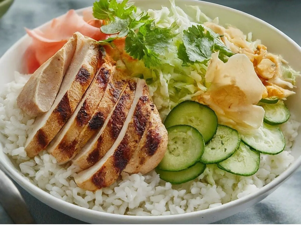 Large Chicken over White Rice with Cucumber, Sweet Onion, Cabbage, Cilantro, Pickled Ginger and Garlic Crisps